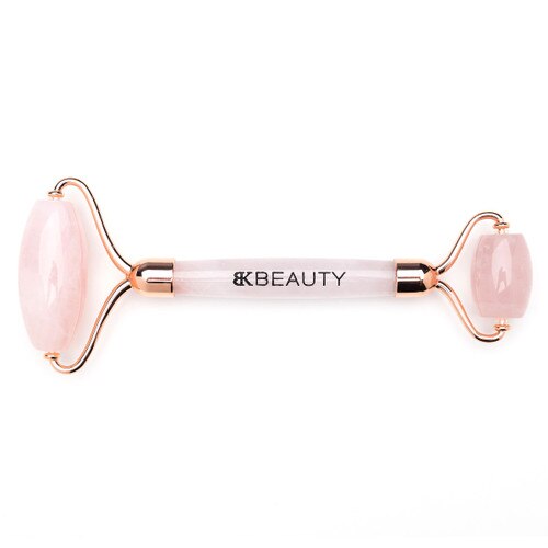 An overhead image of the BK Beauty Face the Day rose quartz face roller on a white background