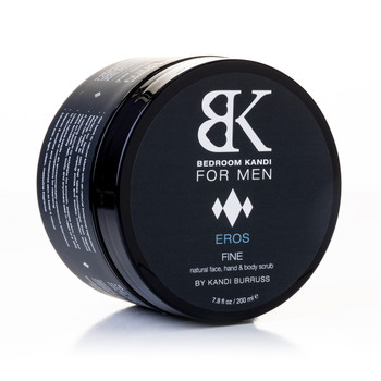 An image of a round black jar of BK for Men's Fine natural face, hand and body scrub, balanced on its side on a white background.