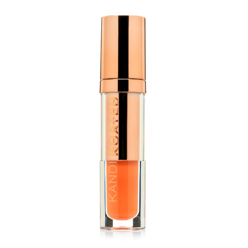 A closed clear and rose gold tube of Lacquer Lip Cream in “Vivacious”, a light orange peach. The tube has Kandi Koated written up the side in rose gold letters and a rose gold cap.