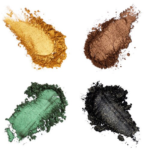 Four converging crumbled smudges of powdered eye shadow in a warm yellow-gold, a deep brown bronze, a dark gray with gold flecks, and a sheer jade green. These belong to “Safari.”