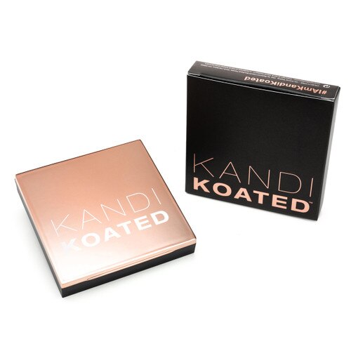 An image of a square compact with a rose gold lid with the frosted Kandi Koated logo. Beside it is its packaging, a black box with rose gold lettering. Both sit on a white background.